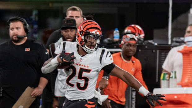 Aug 21, 2022; East Rutherford, New Jersey, USA; Cincinnati Bengals running back Chris Evans (25) gets past New York Giants place kicker Graham Gano (9) on a kickoff return during the second quarter at MetLife Stadium. Mandatory Credit: John Jones-USA TODAY Sports